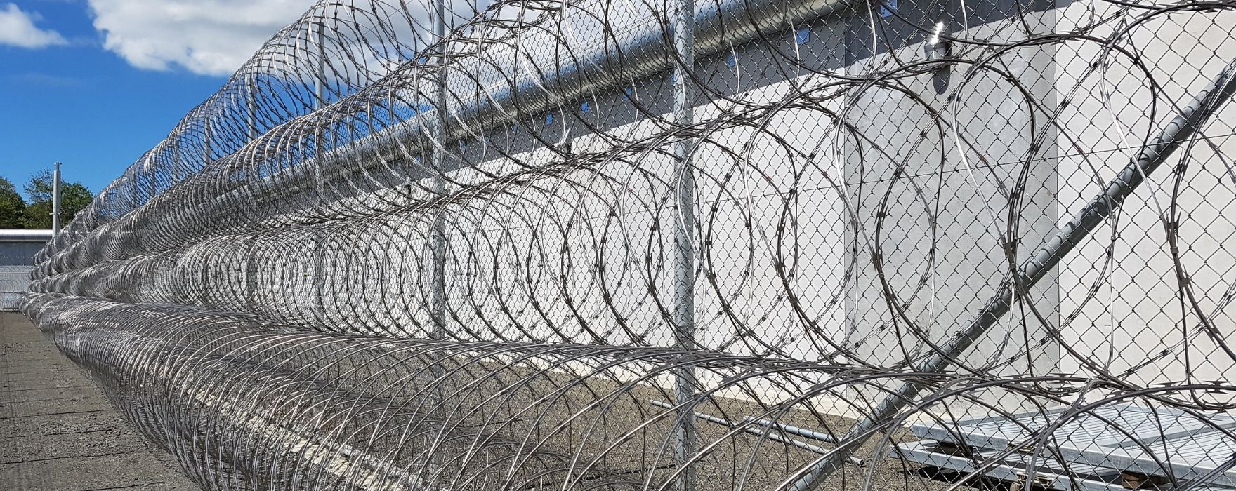 Several coils of cross razor wire work with chain link fence to offer maximum security.